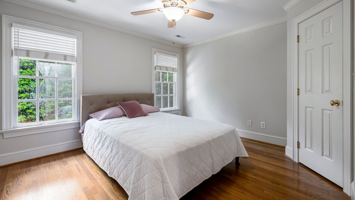 Ceiling fan and vent in a bedroom with two windows to improve bedroom airflow