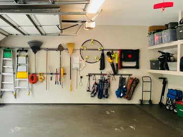 Garage with tools, ladders and shelving on the walls