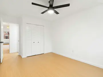 Newly finished bedroom with a ceiling fan and closet
