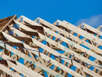 Roof trusses on a new house against a blue sky