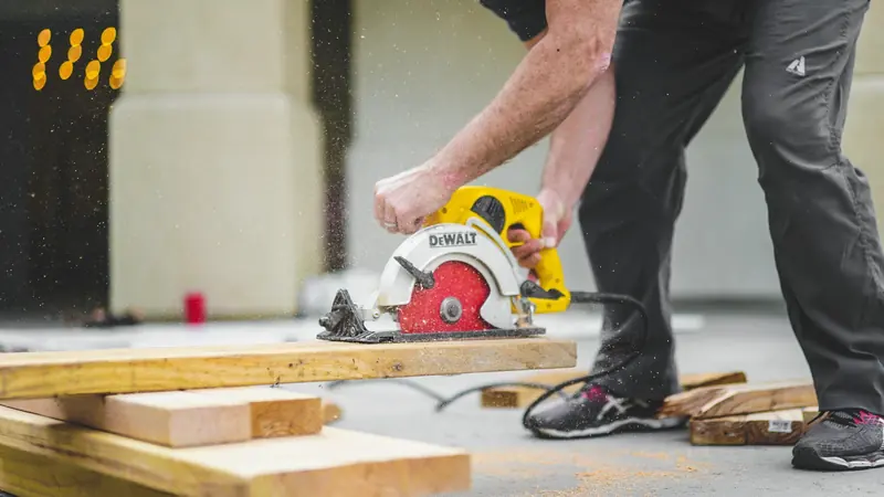Builder cutting a board with a circular saw on a job site