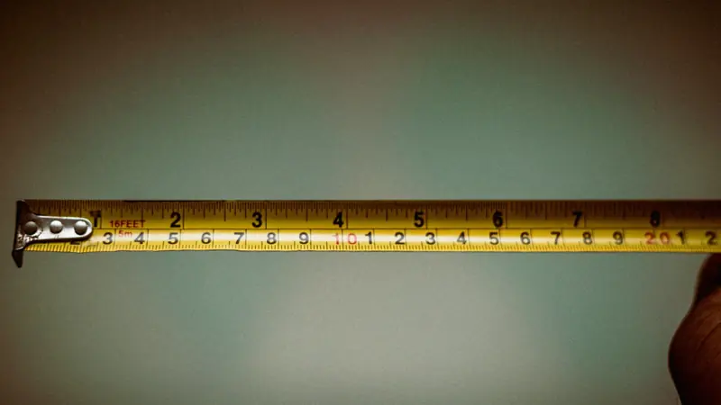 Tape measure pulled out to measure a room for mini split sizing
